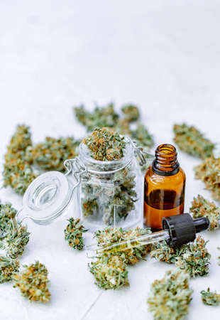 Marijuana buds, oil pills, cbd recreation. Fresh cannabis leaf close up, isolated on white background. Home relaxation, pastime therapy. Alternative medicine.の写真素材