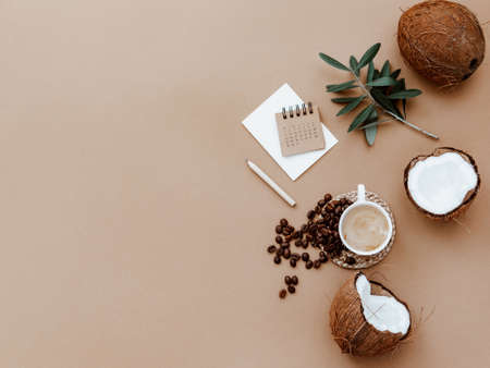 Desktop mockup planner. Flat lay with calendar, blank card, coffee cup and green olive leaves on brown background. Zero waste, eco friendly, natural organic concept.の写真素材