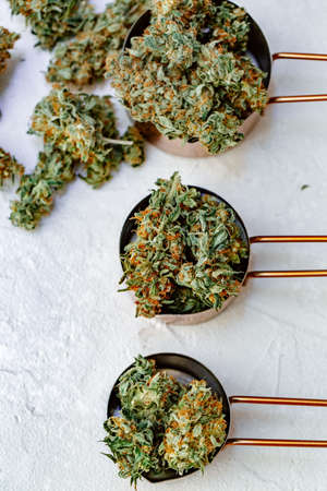 Marijuana buds, leaves and resin, flat lat, top view. Cannabis flowers on gray background. Hemp recreation, home pastime, legalization concept.の写真素材