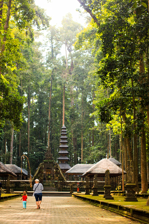 Little girl and grandmother walking in Sangeh Monkey forest in Bali, Indonesia