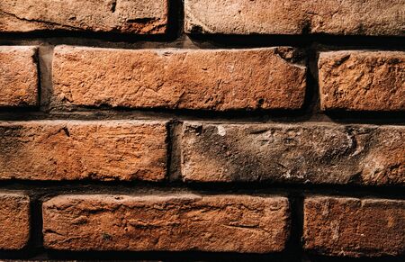 brick texture wall of red, natural, old, battered brick. close-up pattern. wall decoration in the...