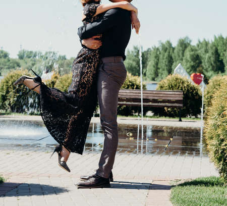 young couple woman in a long elegant lace black dress man in trousers and shirt. love story...