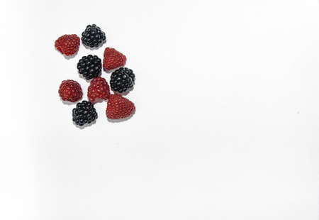 RASPBERRY AND BLACKBERRY on a white background with space for the textの写真素材