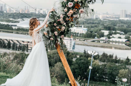 lovely beautiful young slender bride in an airy elegant white wedding dress with lace smile gentle...