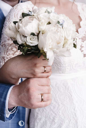 hands of young people with wedding wedding rings. wedding day details. calla flowers. spouses newlyweds groom and brideの写真素材