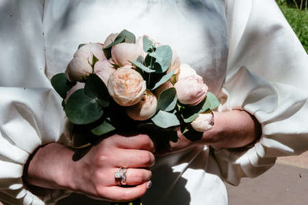 hands of young people with wedding wedding rings. wedding day details. calla flowers. spouses newlyweds groom and brideの写真素材
