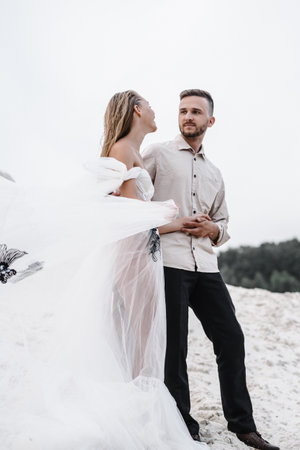 Beautiful wedding couple bride and groom at wedding day outdoors at ocean beach. Happy marriage couple oの写真素材