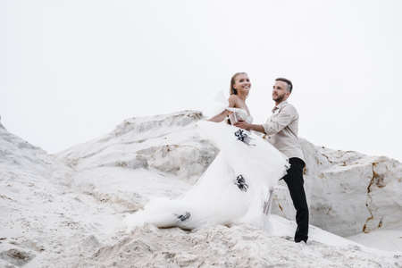 Beautiful wedding couple bride and groom at wedding day outdoors at ocean beach. Happy marriage couple oの写真素材