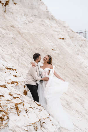 Beautiful wedding couple bride and groom at wedding day outdoors at ocean beach. Happy marriage couple oの写真素材