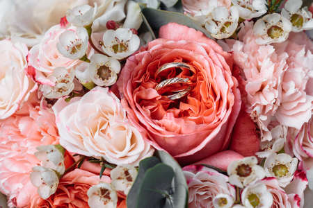 hands of young people with wedding wedding rings. wedding day details. calla flowers. spouses newlyweds groom and brideの写真素材
