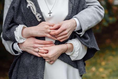 hands of young people with wedding wedding rings. wedding day details. calla flowers. spouses newlyweds groom and brideの写真素材