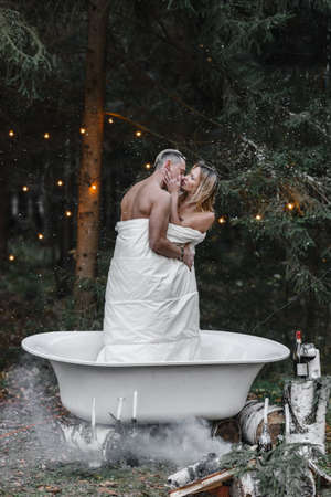 a couple of lovers in a bath in the forest passion love tenderness sexuality touching the spouse intimacy kissの写真素材