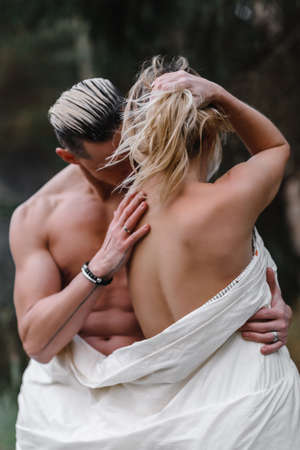 a couple of lovers in a bath in the forest passion love tenderness sexuality touching the spouse intimacy kissの写真素材