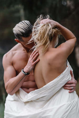 a couple of lovers in a bath in the forest passion love tenderness sexuality touching the spouse intimacy kissの写真素材