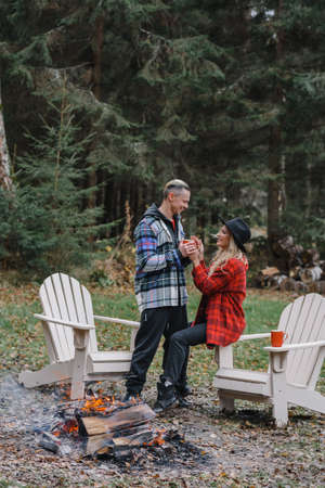couple kissing. lovers tenderness steam white on path the forest romance stylish passionate by the campfire in the forest picnic fire romanceの写真素材