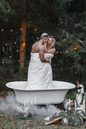 a couple of lovers in a bath in the forest passion love tenderness sexuality touching the spouse intimacy kissの写真素材