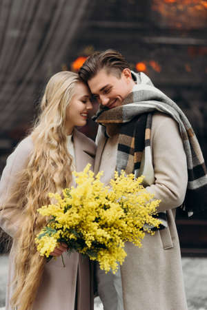 lovestory couple Love coat beige gray white bouquet of flowers tenderness feelings walk Hug dateの写真素材