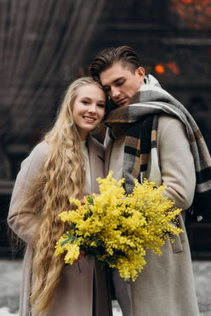 lovestory couple Love coat beige gray white bouquet of flowers tenderness feelings walk Hug dateの写真素材