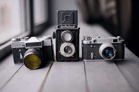 Three Old Reflex Cameras Isolated On Wooden Background vintage twin Lens reflex cameraのeditorial素材