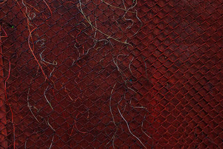 Vintage aged rusty metal wall with rabitz. Iron metal wall with rusted and aged metal grid. The wall of abandoned barnの写真素材