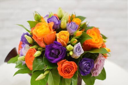 bouquet of flowers in vase on tableの写真素材