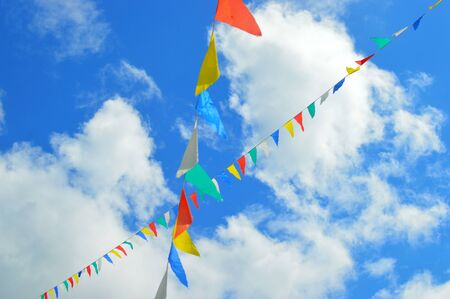 multi-colored flags in the blue skyの写真素材