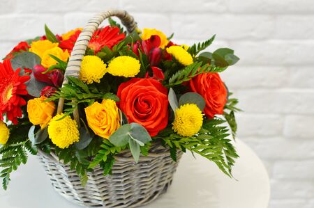 big bright basket with colorful flowersの写真素材