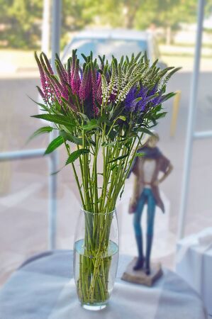 Romantic bouquet of colorful flowers at a windowの写真素材