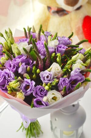 Romantic bouquet of lilac flowers at a windowの写真素材