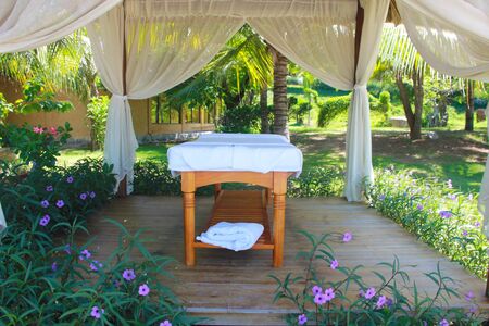 Spa tables at beachside in bungalow, massage tables with towels. Beauty care concept. Spa beds ready to massage at outdoors tropical island resort.の写真素材