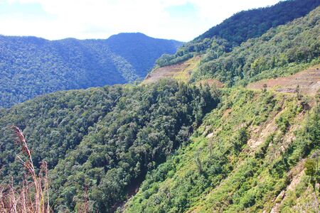 Mountain road. Landscape with rocks, clouds and asphalt road. Highway in mountains. Green hills mountain view in summer.の写真素材
