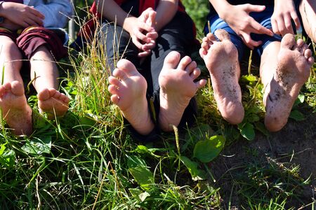Type of heels and fingers of teenagers. Cheerful children walk on the street. Summer school...