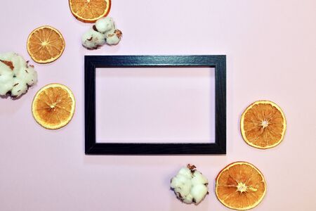 Pink wallpaper with decorative floral elements. Slices of dry orange, cinnamon on pinkの写真素材