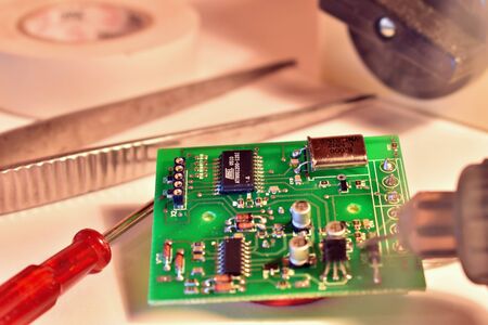 The electric chip is repaired with a soldering iron. Repair of household appliances. Digital...