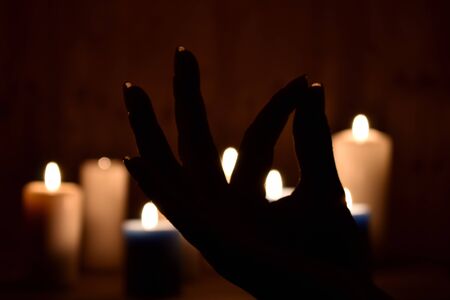 Candlelight meditation at night. Religious Buddhist symbol. Calmness and pacification background.の写真素材