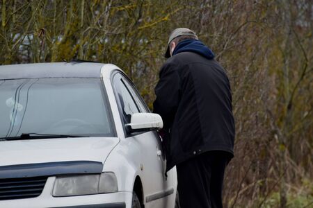 A person opens car door. Security car system.