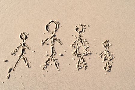Men drawn in the sand. Happy Family on the beach. Family pattern of the sea. In vacation with...