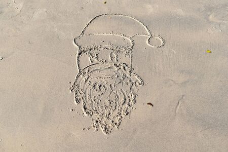New year's drawings on the sand. Christmas on sea.の写真素材