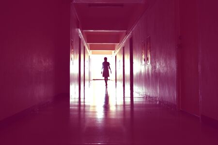 Light at the end of the tunnel. The path to the afterlife. The life after death. Creepy long dark hallway. A ghost in the tunnelの写真素材