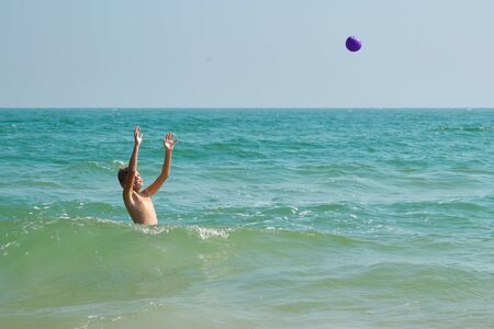 Boy child playing in the sea. Child splashing in the water autdoor. Your holidays at sea. Games in...