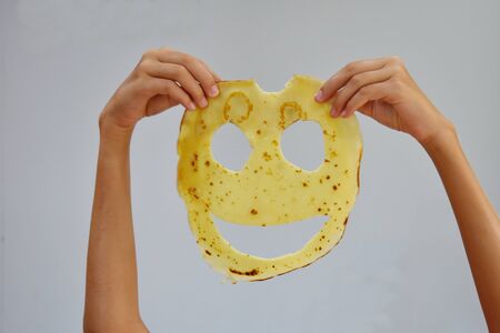 A child plays with food. Russian traditional pancakes.のeditorial素材