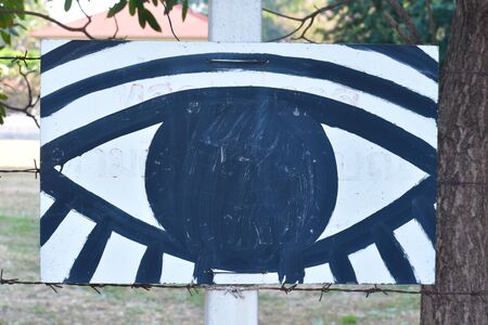 Black large painted symbol of the eye. Eyes on the wall.のeditorial素材