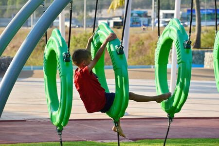 The little boy on the Playground. The child is an active athlete. Children's play area.の写真素材