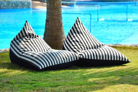 cozy Paradise under the palm trees to the sea. Two chairs in a tropical country. A beautiful ocean...