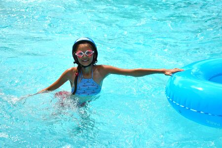 The water rides in the tropics. Girl swims in the water Park.