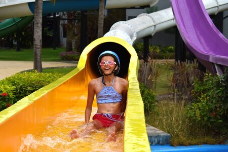 Happy child in the water Park. Girl in the pool in the summer autdoor.の写真素材