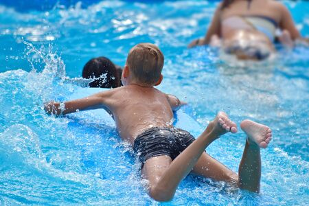 Baby boy on a water board. Stay in the water Park in the summer.