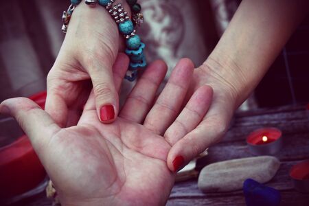Palm divination. Magic and fraud. A woman fortune-teller predicts the futureの写真素材