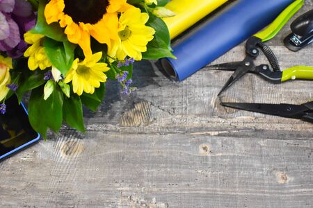 Floral bouquets on the table. Floral background. Tools of the florist.