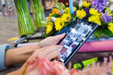 Online flower shop. Flower business in the Internet. Remote ordering flowersのeditorial素材